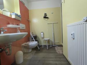 a bathroom with a sink and a toilet at Ferienappartement Bademantelzugang zur Therme in Bad Griesbach +16 photos