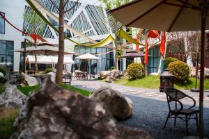 A garden outside Sandstone Painting Handicraft Exchange Gallery Hotel