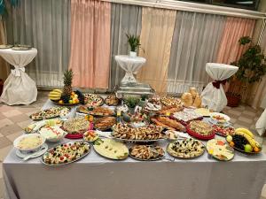 a table topped with lots of different types of food at Hotel Bosna in Kladanj