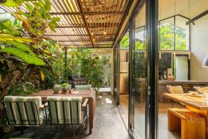a patio with a table and chairs and plants at Loft 7 Villa by Betterplace in Canggu