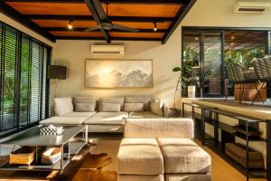 a living room with a couch and a table at Loft 7 Villa by Betterplace in Canggu