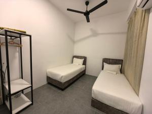 a room with two beds and a ceiling fan at Simfoni Comfy Premium 03 in Langkawi Islands +27 photos