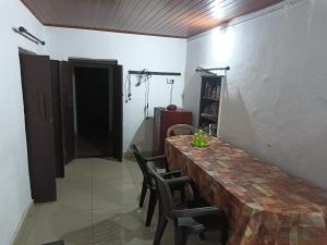 a dining room with a wooden table and chairs at Wintervilla Cottages in Meppādi +10 photos