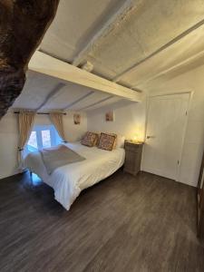 a bedroom with a large bed in a room at La Cour in Villefagnan