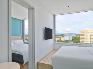 a bedroom with two beds and a large window at Tru By Hilton Tam Ky City Centre in Tam Ky +23 photos