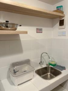 a kitchen counter with a sink and a bowl on a shelf at Apt Minimalis Tokyo Riverside at PIK2 in Muara +8 photos
