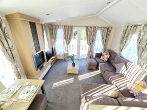 a living room with a couch and a tv at Birchington Vale Robertsbridge in Manston