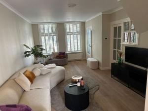 a living room with a couch and a flat screen tv at Beautiful entire house in the center in Medemblik