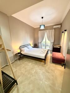 a bedroom with a bed and a window at Plaza Vista in Kalamata
