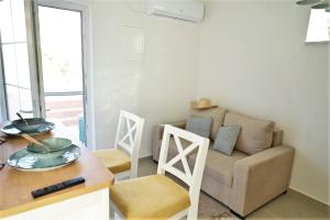 a living room with a couch and a table at Apartment ART Murter in Murter