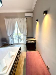 a bedroom with two beds and a large window at Plaza Vista in Kalamata