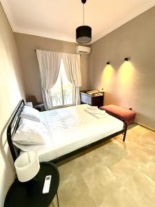 a bedroom with a large bed and a window at Plaza Vista in Kalamata