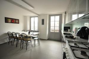 a kitchen with a table and chairs in a room at Townhouse II Sleeps 12 guests Central in Interlaken