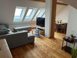a living room with a couch and a flat screen tv at Ferienwohnung Kampesberg in Kirchham