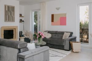 a living room with two couches and a fireplace at Villa Oleander by Domus Mirus - Rooftop Cinema & Pool & 6min Walk to Beach in Splitska