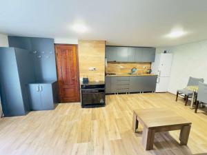 a large kitchen with a table in a room at House Lia Apartment Likani in Borjomi +4 photos