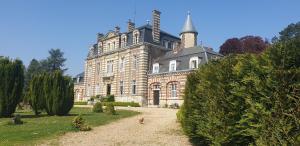 an old house with a chimney on top of it at Chateau de Sommesnil in Sommesnil