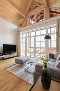a living room with a couch and a table at Dachstein Residenzen in Bad Aussee