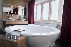 ハンブルクにあるBettenburg Hotelの窓のある浴室にある大きな白い浴槽 +36枚の写真
