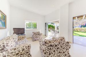 a living room with couches and a flat screen tv at Charming Cala San Vicente Villa Private Pool Villa Pins Resort Centre Location in Cala de Sant Vicent +7 photos