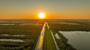 an aerial view of a river at sunset at Nest - luxe wellness met privé sauna in Friesland in Luxwoude