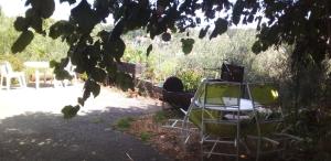 a group of chairs and tables in a yard at Micro-ferme agroécologique in Joyeuse