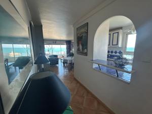 a living room with a hallway with a view of the ocean at Superbe appartement 2 chambres face à la mer au Grau du Roi l'Impérial in Le Grau-du-Roi