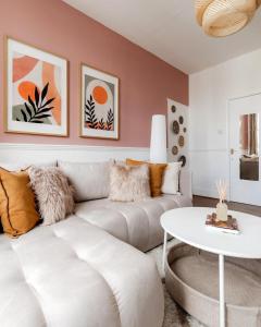 a living room with a couch and a table at West Kensigton Superb Apartments! in London