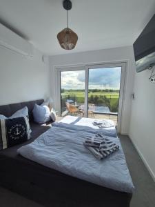 a bedroom with a bed and a large window at elbeins in Bittkau