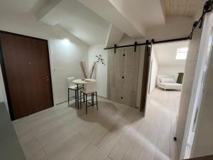 a room with a table and chairs and a door at Lucciano Suite in Quarrata