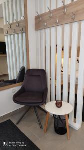 a chair and a table in front of a crib at MAKS 2 Osijek Center, self check in in Osijek