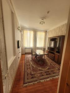 a living room with a table and a rug at STOP Hotel in Sheki