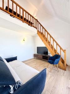 a bedroom with a large bed and a staircase at Duplex plein charme Face mer & déco moderne in Quiberon +31 photos