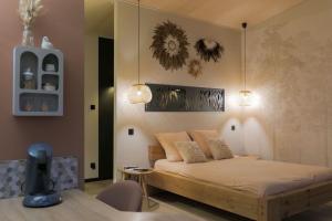 a bedroom with a bed in a room at L'écolodgia suite & spa in Saint-Étienne-lès-Remiremont