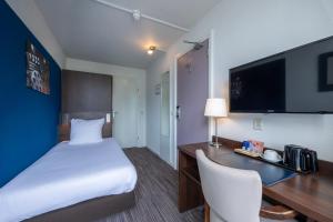 Postel nebo postele na pokoji v ubytování Amrâth Hotel Media Park Hilversum
