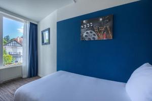 Postel nebo postele na pokoji v ubytování Amrâth Hotel Media Park Hilversum