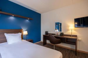 Postel nebo postele na pokoji v ubytování Amrâth Hotel Media Park Hilversum