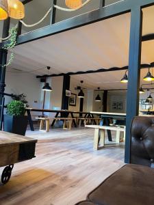 a room with tables and chairs and pendant lights at Bajamar hostel in Laredo +38 photos