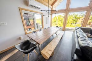 a dining room with a wooden table and chairs at Chalet en montagne - Spa et Ski - Le Goathouse in Saint-Philémon +31 photos