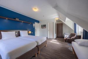 Postel nebo postele na pokoji v ubytování Amrâth Hotel Media Park Hilversum