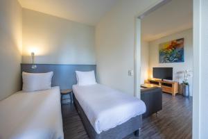 Postel nebo postele na pokoji v ubytování Amrâth Hotel Media Park Hilversum