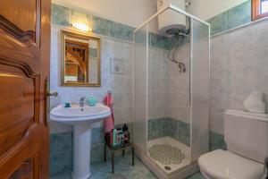 a bathroom with a sink and a shower at Maroulas House in Chrysomiléa
