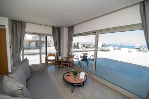 a living room with a view of a swimming pool at Jasmine Hotel Apartments in Kos