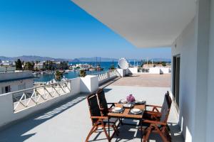a patio with a table and chairs on a balcony at Jasmine Hotel Apartments in Kos