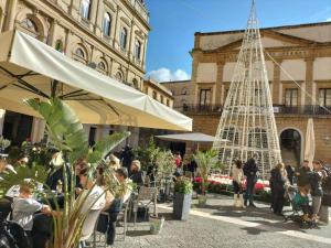 a group of people standing in front of a christmas tree at Artemide B&B in Caltagirone