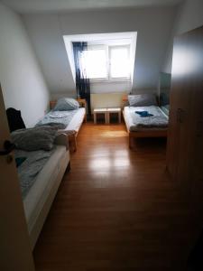a bedroom with two beds and a window at Siegen Monteuren Wohnung 6 in Siegen