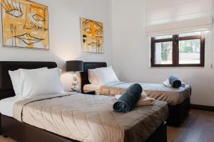 a bedroom with two beds and a window at Aphrodite Premium Apartments I in Kouklia +72 photos