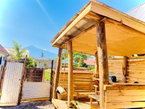 a wooden building with a porch and a fence at Shambani House in Arusha