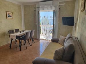 a living room with a couch and a table with chairs at Villa-Panorama in Drage