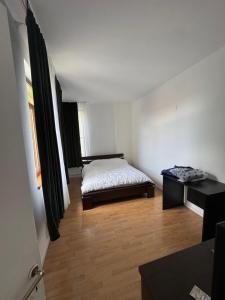 a bedroom with a bed and a table in it at TS House in Cluj-Napoca